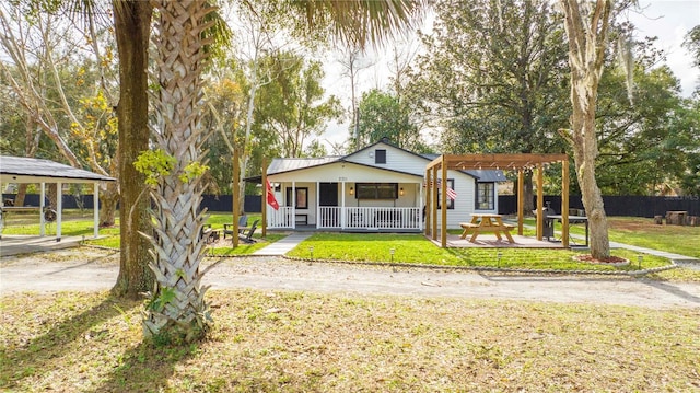 bungalow-style house with a porch, a pergola, and a front lawn