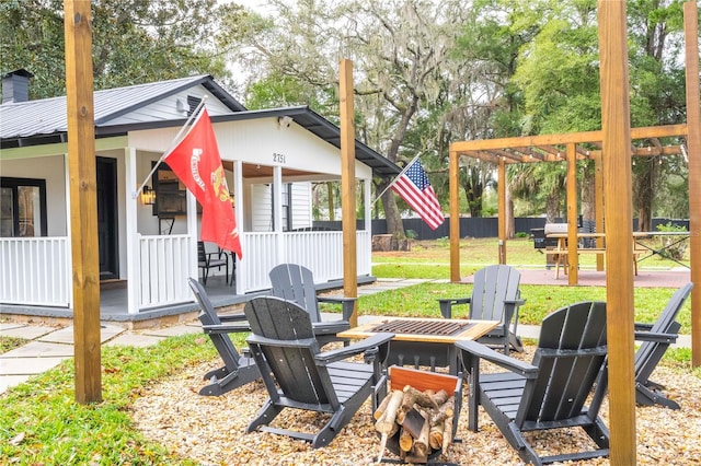 view of yard with a pergola and an outdoor fire pit