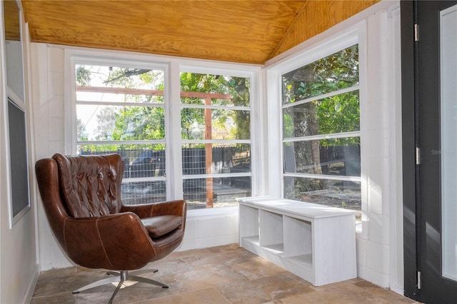 sunroom / solarium featuring vaulted ceiling