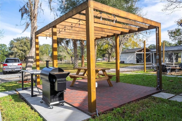 view of property's community with a lawn, a pergola, and a patio area