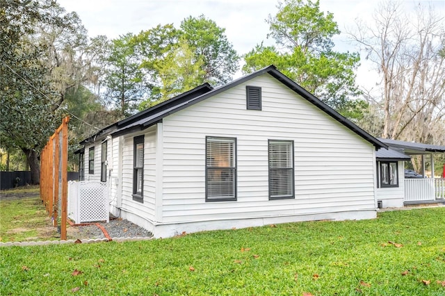 view of side of home featuring a yard