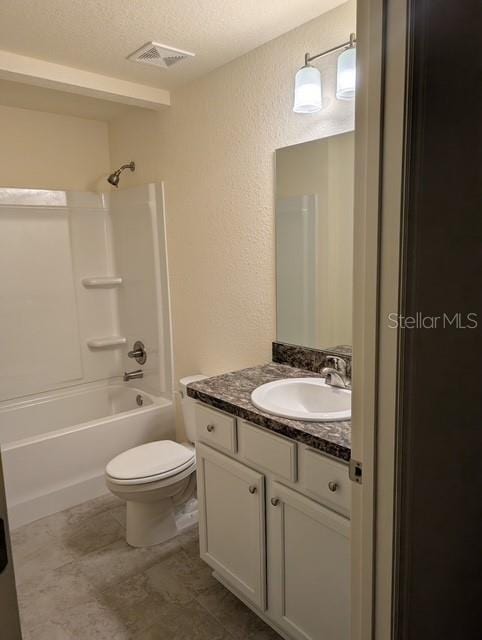 full bathroom with vanity, shower / tub combination, a textured ceiling, and toilet