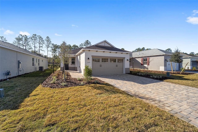 view of front of home featuring central AC unit, a garage, and a front lawn