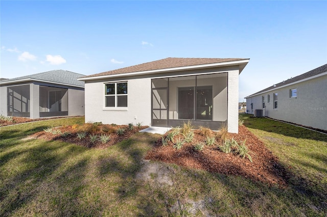 rear view of property with a yard, cooling unit, and a sunroom