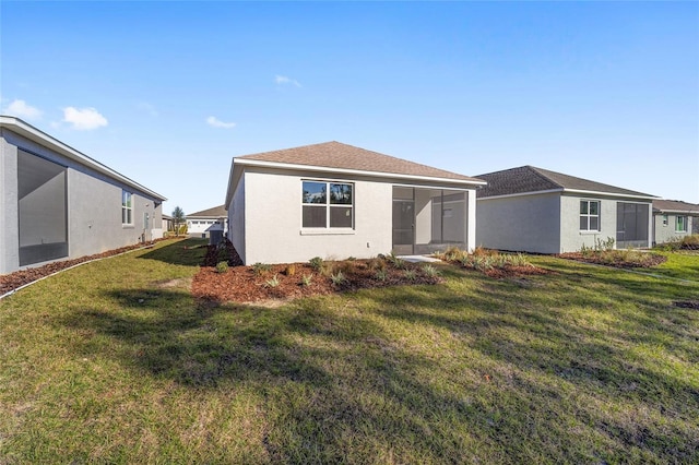 view of front of home with a front lawn and a sunroom