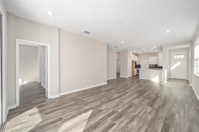 unfurnished living room featuring hardwood / wood-style floors