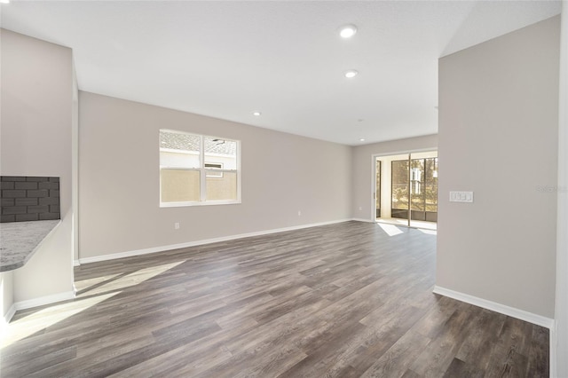 unfurnished living room featuring dark wood-type flooring