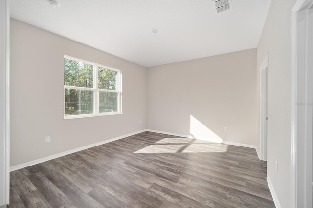 unfurnished room featuring dark wood-type flooring