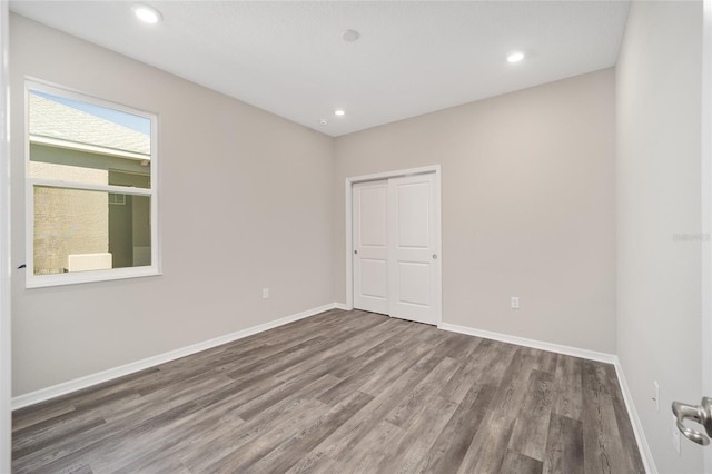 empty room with hardwood / wood-style floors