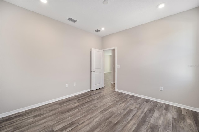 spare room featuring dark hardwood / wood-style flooring