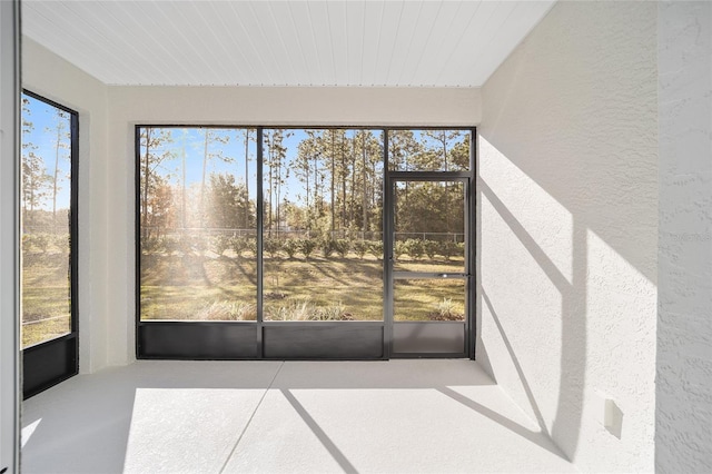 unfurnished sunroom featuring wood ceiling