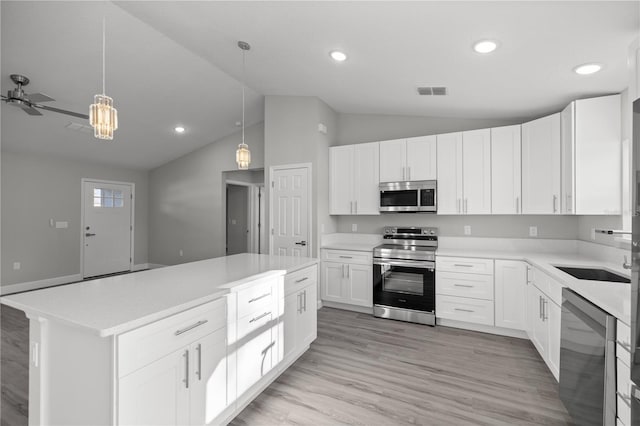 kitchen with ceiling fan, decorative light fixtures, white cabinetry, and appliances with stainless steel finishes