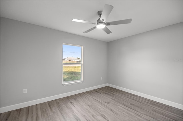 empty room featuring ceiling fan and light hardwood / wood-style flooring