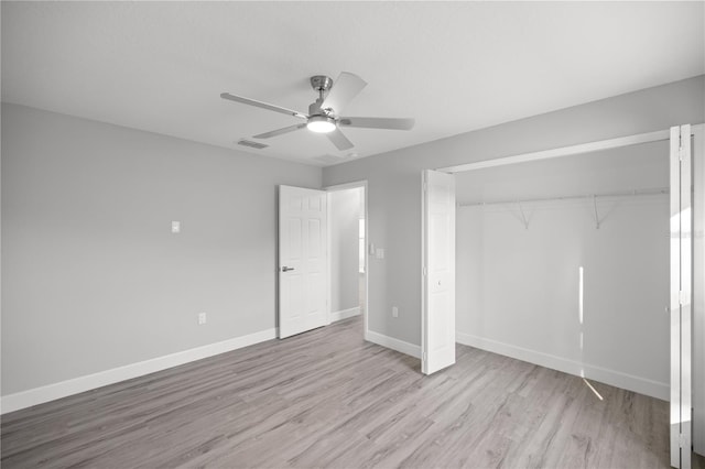 unfurnished bedroom featuring ceiling fan, light hardwood / wood-style flooring, and a closet