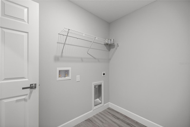 laundry area featuring hookup for an electric dryer, hookup for a washing machine, and light hardwood / wood-style floors