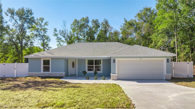 ranch-style home featuring a garage and a front lawn