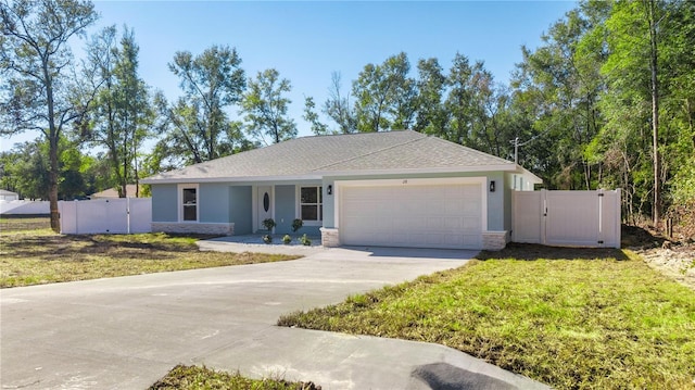 single story home featuring a garage and a front lawn