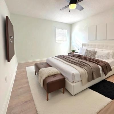 bedroom with ceiling fan and light wood-type flooring