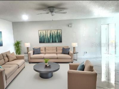 living room featuring a textured ceiling and ceiling fan