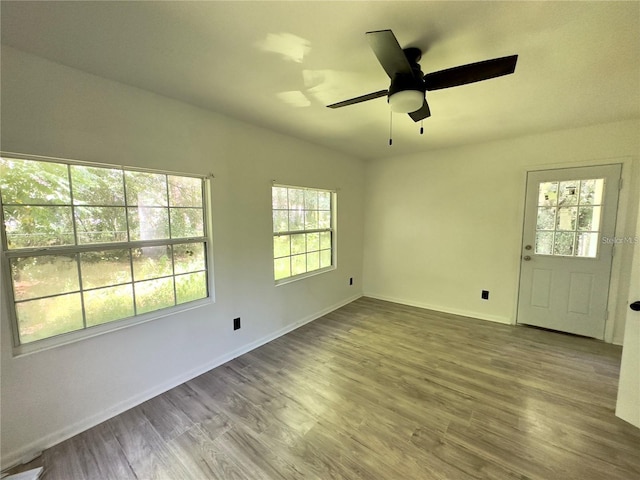 unfurnished room with hardwood / wood-style flooring, vaulted ceiling, and ceiling fan