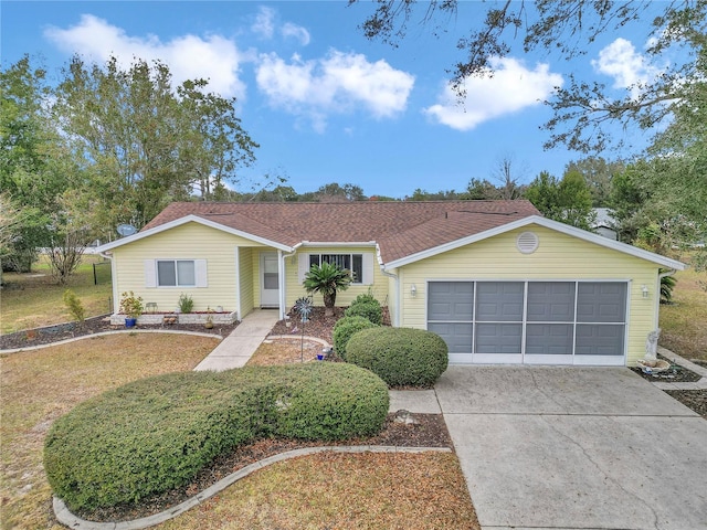 ranch-style home featuring a front yard and a garage