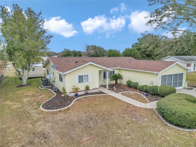 ranch-style house with central AC and a front yard