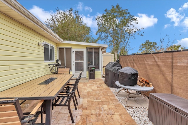 view of patio / terrace featuring a sunroom and radiator heating unit