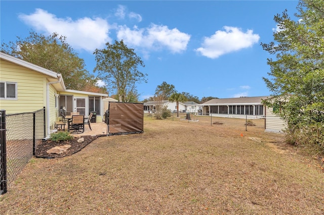 view of yard with a sunroom and a patio