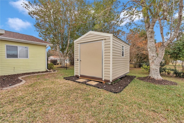 view of outbuilding featuring a yard