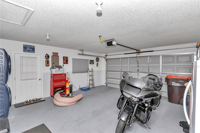 garage featuring a garage door opener and stainless steel refrigerator