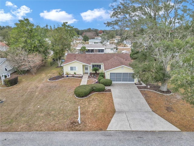 view of front of house featuring a garage and a front lawn