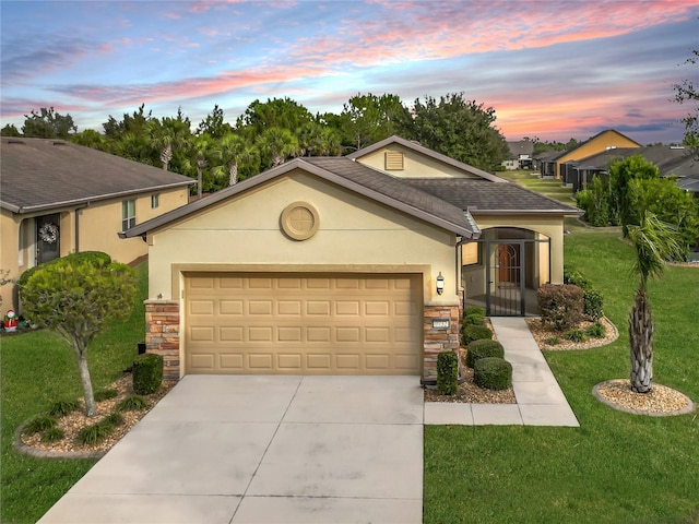 view of front of property with a lawn and a garage