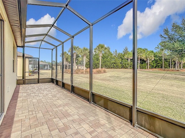 unfurnished sunroom with lofted ceiling