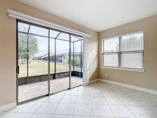 doorway with light tile patterned flooring