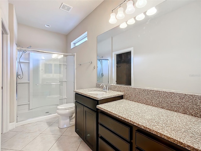 bathroom featuring tile patterned floors, a shower with door, vanity, and toilet