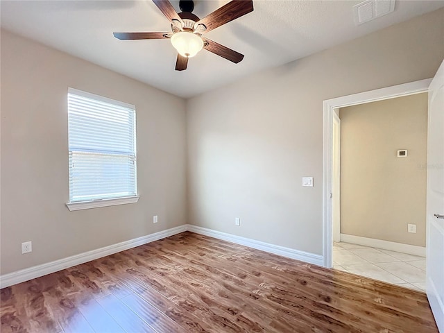 spare room with ceiling fan and light hardwood / wood-style floors