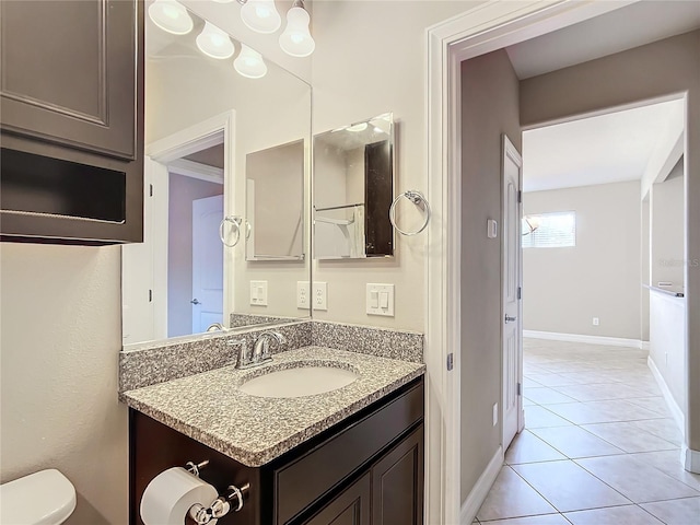 bathroom with tile patterned floors, vanity, toilet, and crown molding