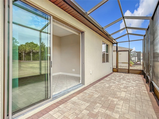 unfurnished sunroom featuring lofted ceiling