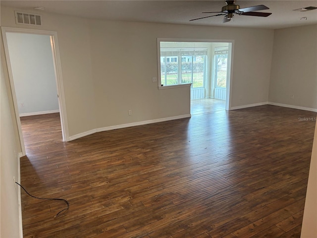 unfurnished room featuring ceiling fan and dark wood-type flooring