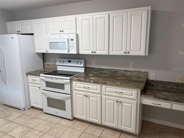 kitchen with white cabinetry, white appliances, and light tile patterned floors