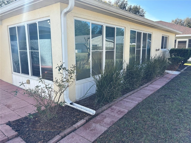 view of side of home featuring stucco siding