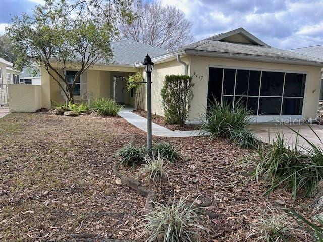 back of house with fence and stucco siding