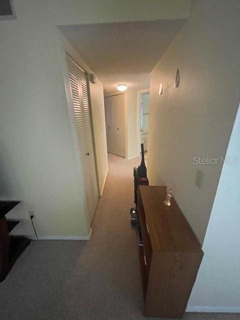7945 Midway Drive Ter Unit H201, Ocala, FL 34472 - hallway with carpet floors and baseboards