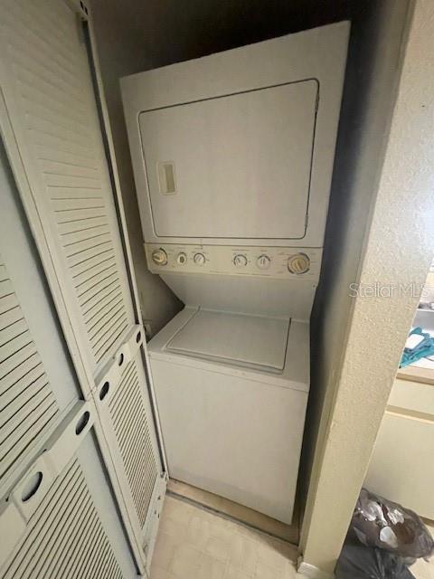 7945 Midway Drive Ter Unit H201, Ocala, FL 34472 - laundry room with stacked washer and clothes dryer
