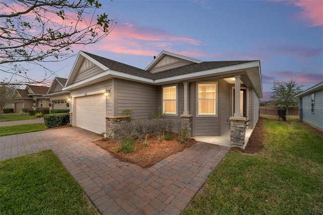 view of front facade featuring a yard and a garage