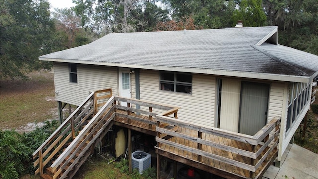 rear view of house with central AC and a wooden deck