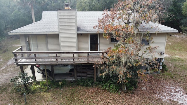 rear view of property featuring a wooden deck