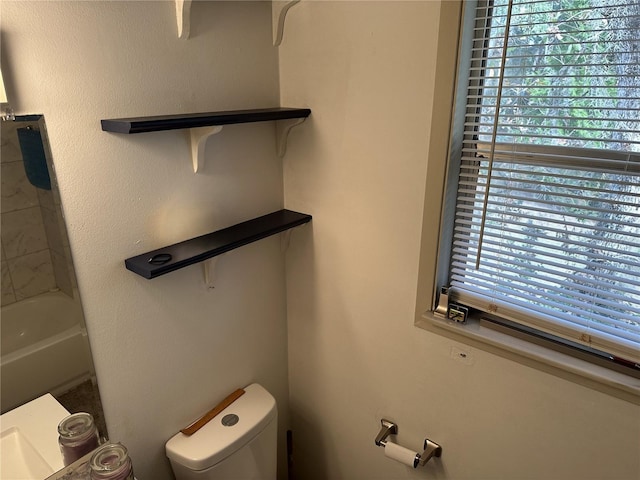 bathroom featuring toilet and plenty of natural light