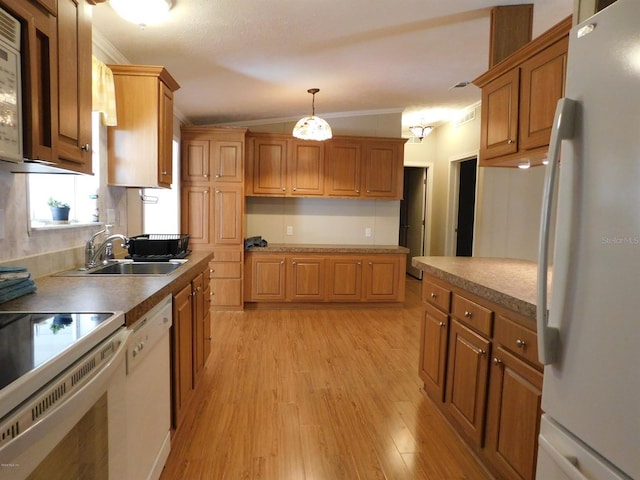 kitchen featuring light wood-type flooring, ornamental molding, white appliances, vaulted ceiling, and hanging light fixtures