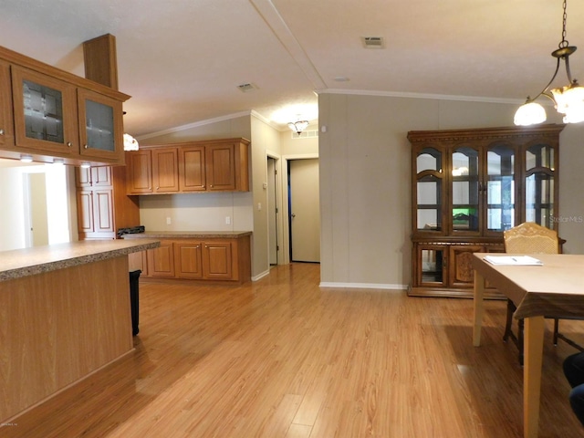 kitchen featuring a notable chandelier, decorative light fixtures, and ornamental molding